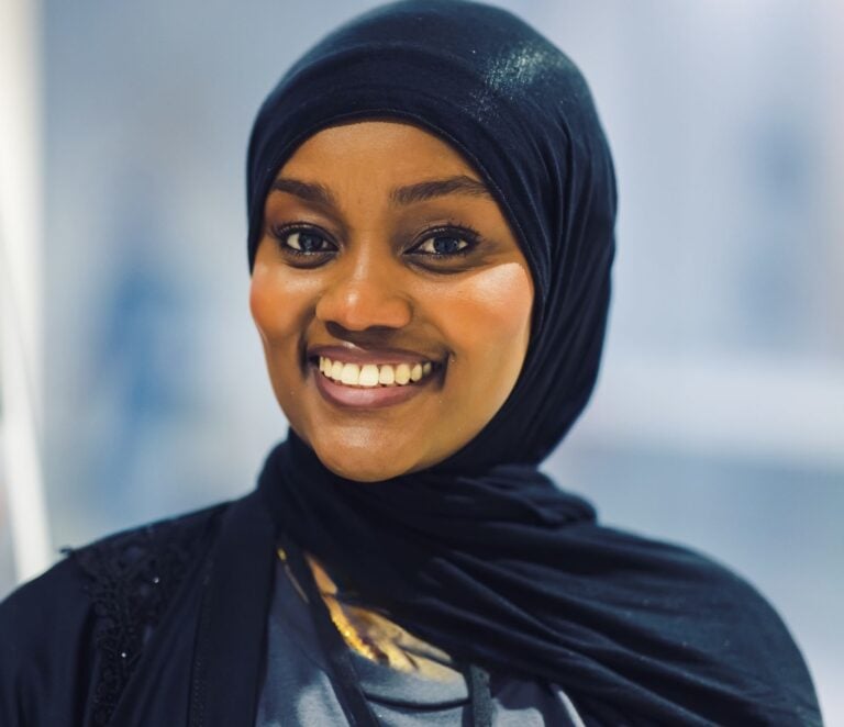 Woman wearing a headscarf and smiling
