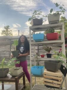 Smiling woman among plants at a nursery