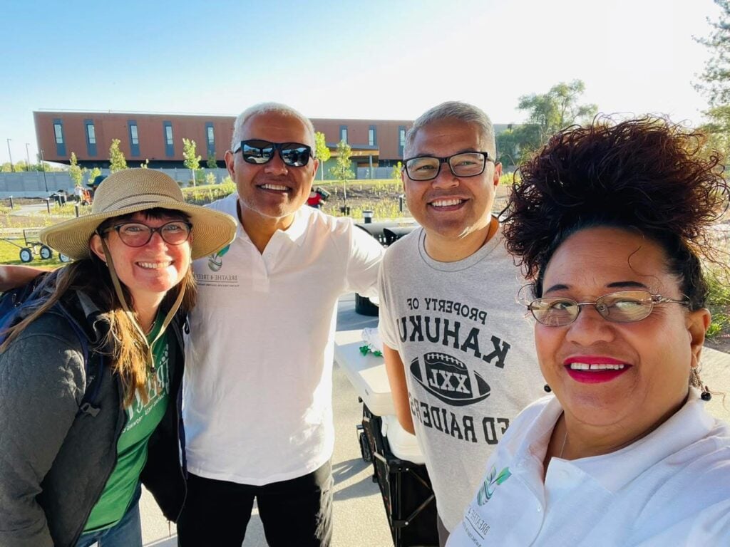 Four people smiling outdoors