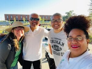 Four people smiling outdoors