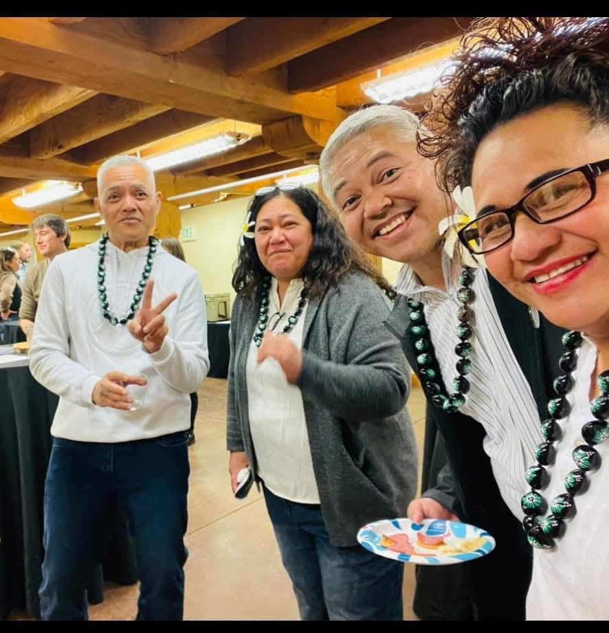 Four people smiling at an event