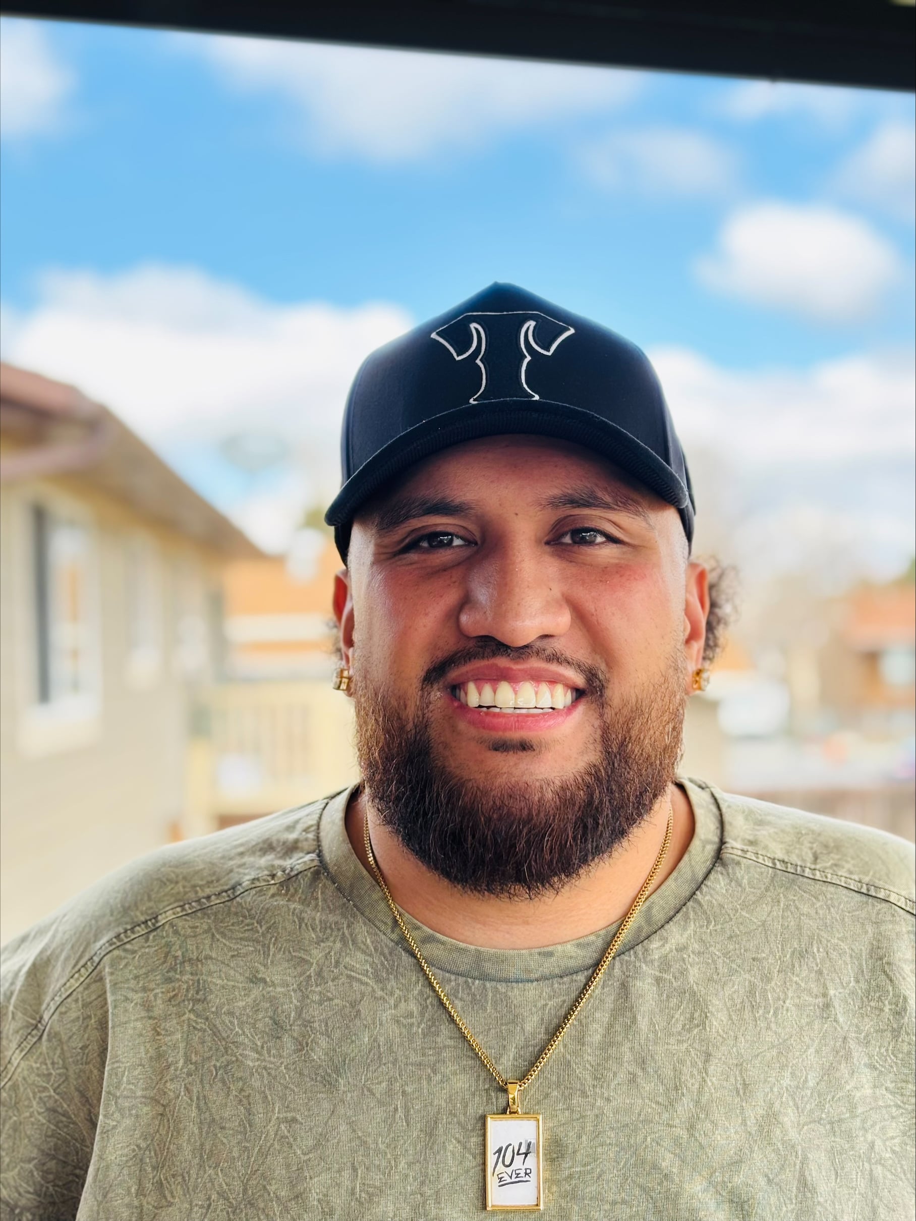Man wearing a baseball cap and smiling