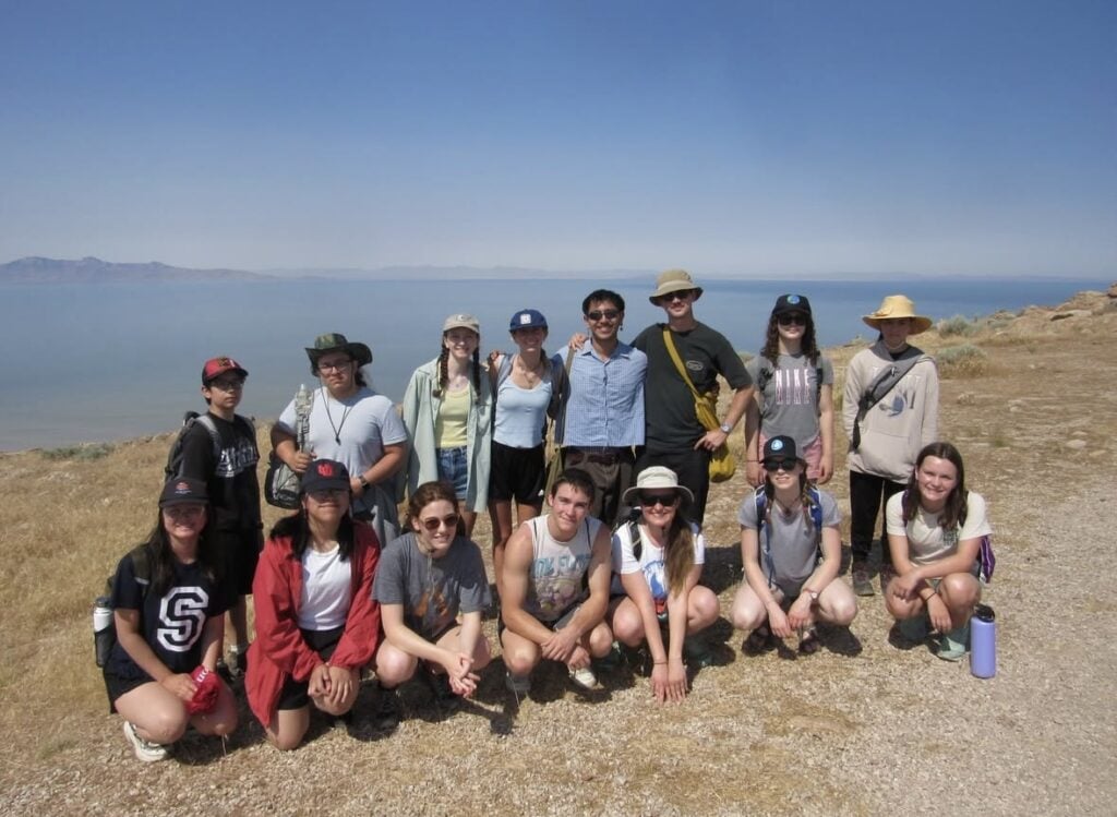 Group of people smiling in front of a vista outdoors