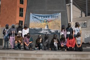 Group of people outside a building with a Salt Lake 2031 Olympics banner