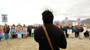 Back view of a person speaking at a protest